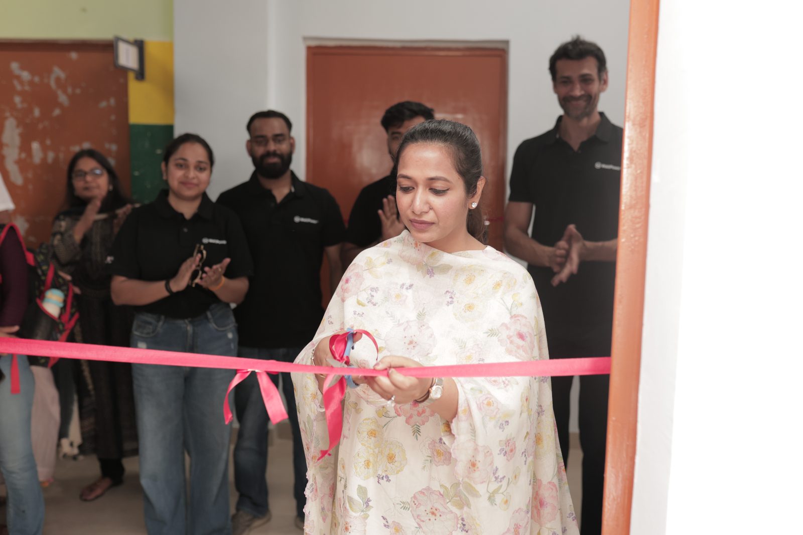 Chairperson cutting the ribbon at the new classroom