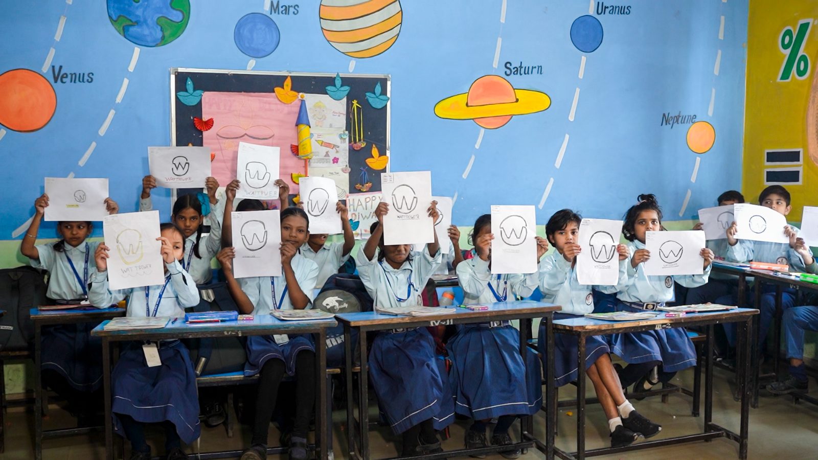 Children holding their WattPower drawings