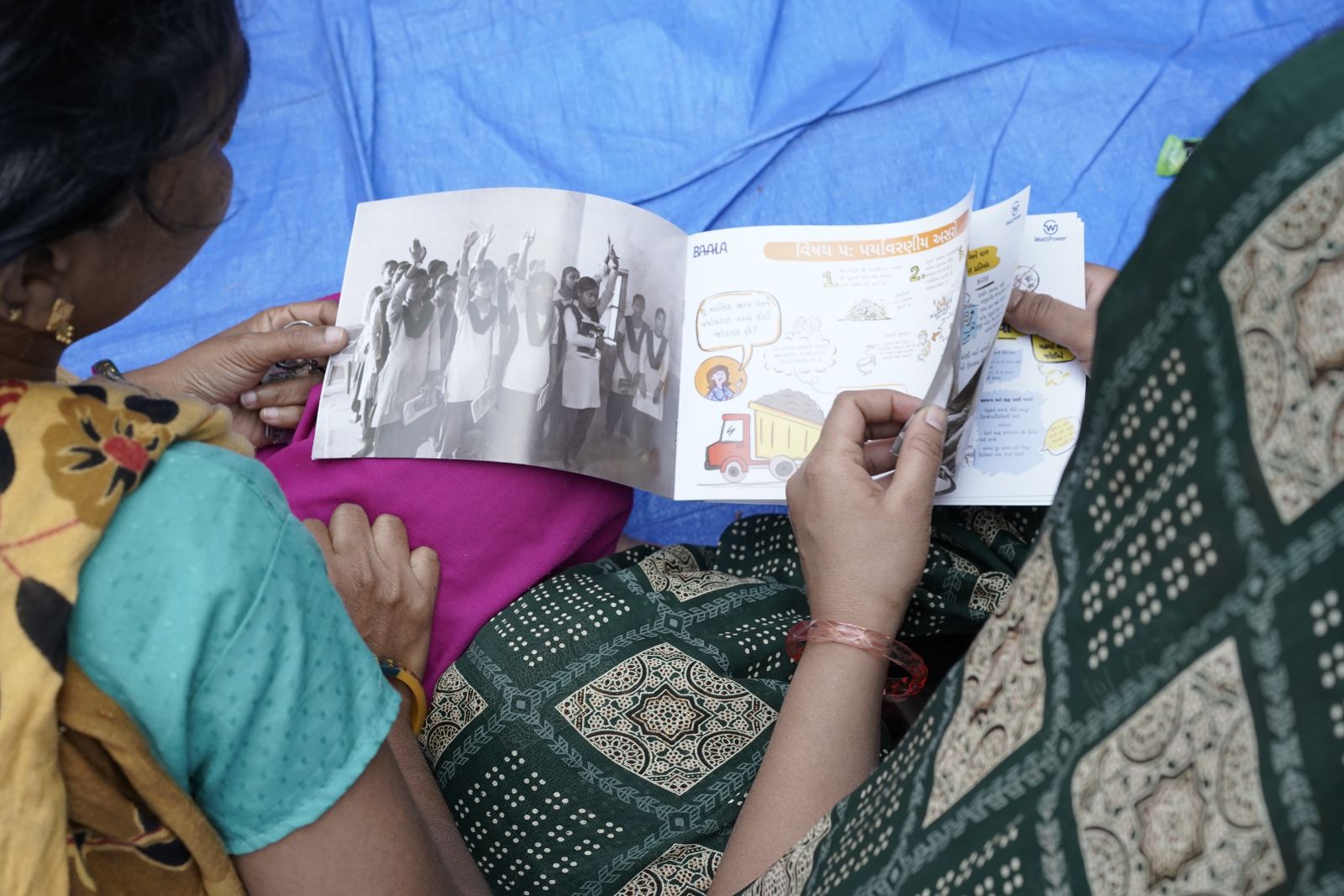 Woman reading the Baala illustration booklet
