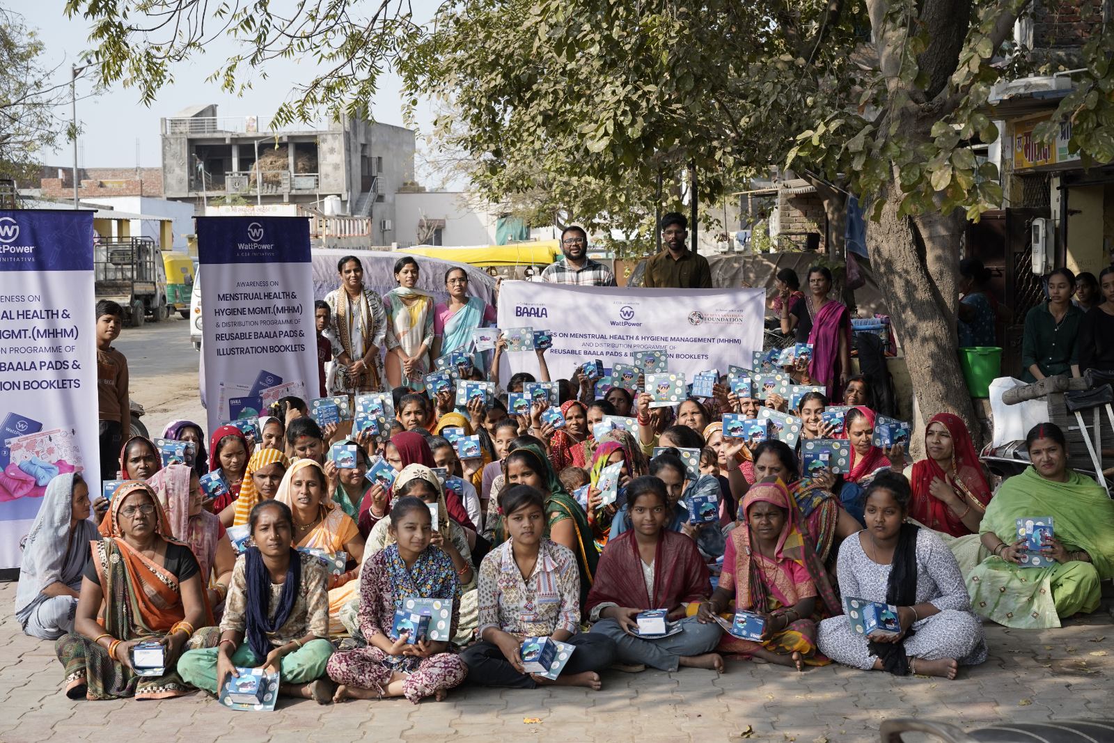 Women holding their reusable Baala pad kits